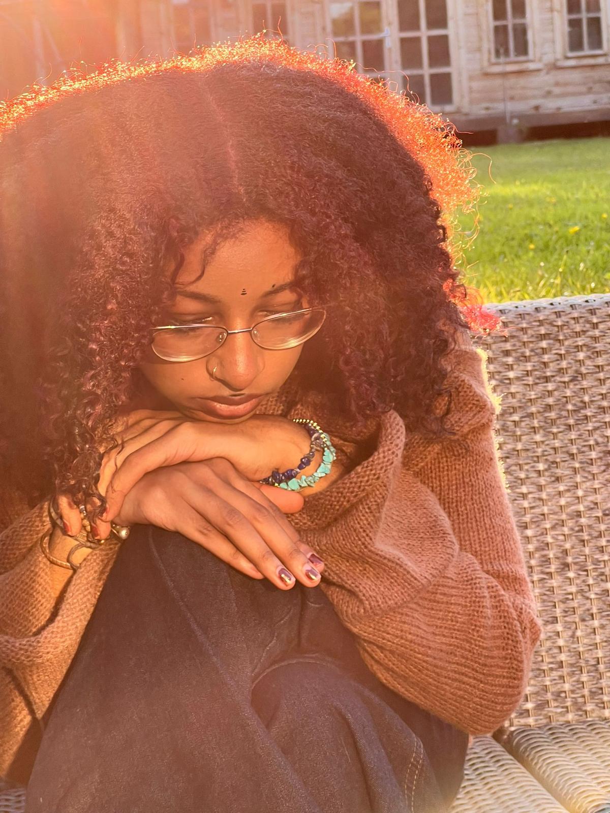 Close garden portrait of Alanna Crouch in warm sunlight.